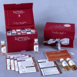 coffret rouge avec noeud calendrier de l'avent le club des connaisseurs 2024 contenant 24 rhums de pays et saveurs différentes